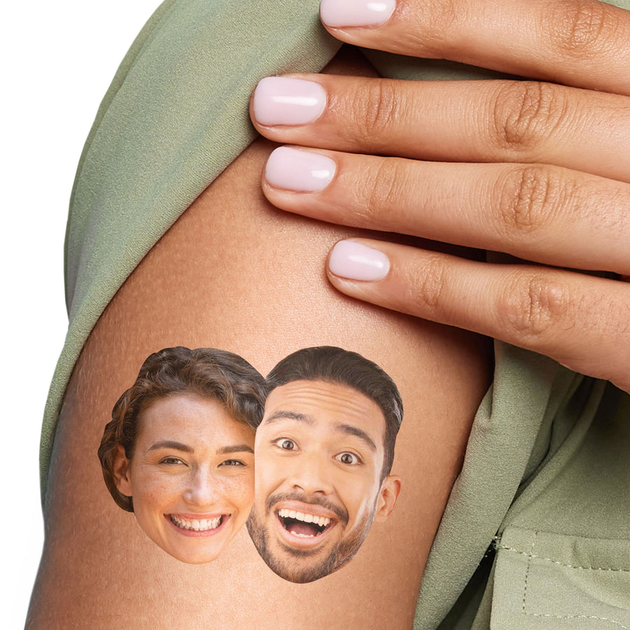 A close-up of a person's arm with two custom temporary tattoos featuring the faces of two individuals.