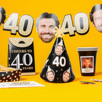 40th birthday party decorations with face cutouts, hats, and cards on a yellow background