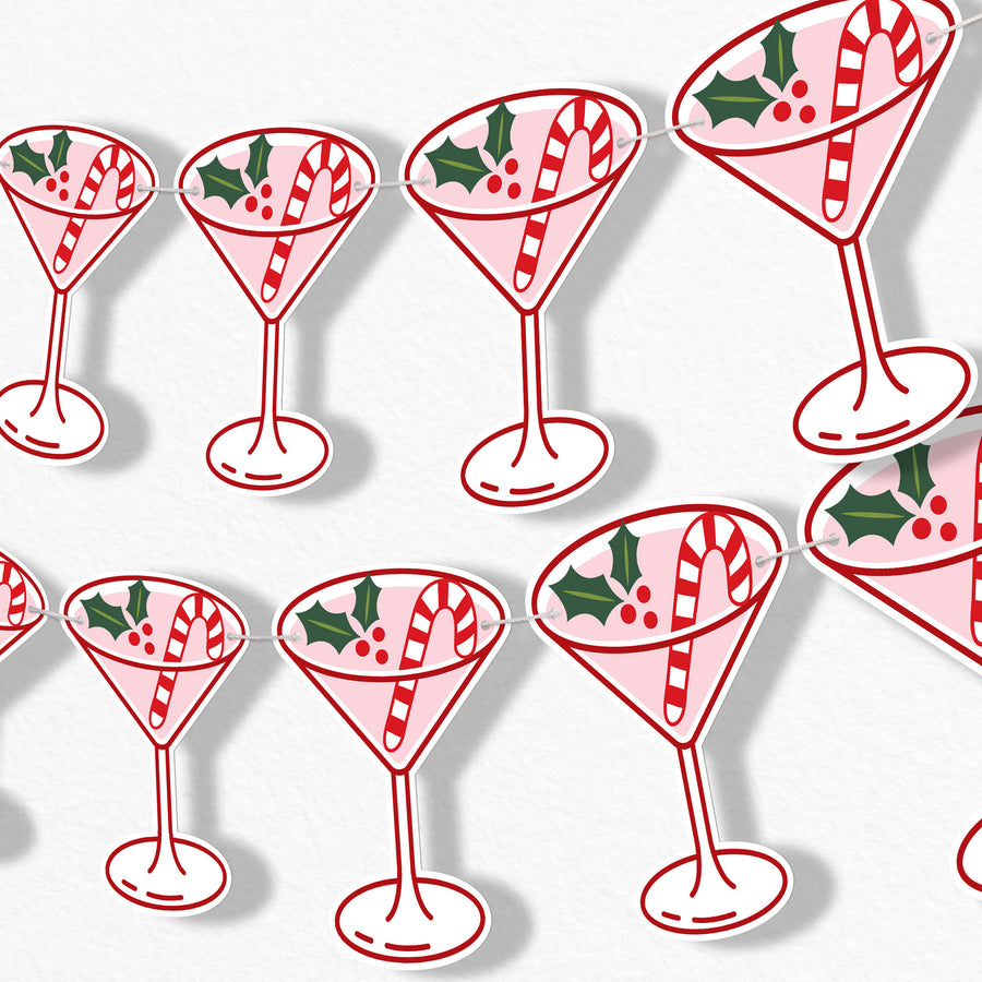 Banner Christmas-themed cocktail glasses with candy canes and holly leaves on a white background.