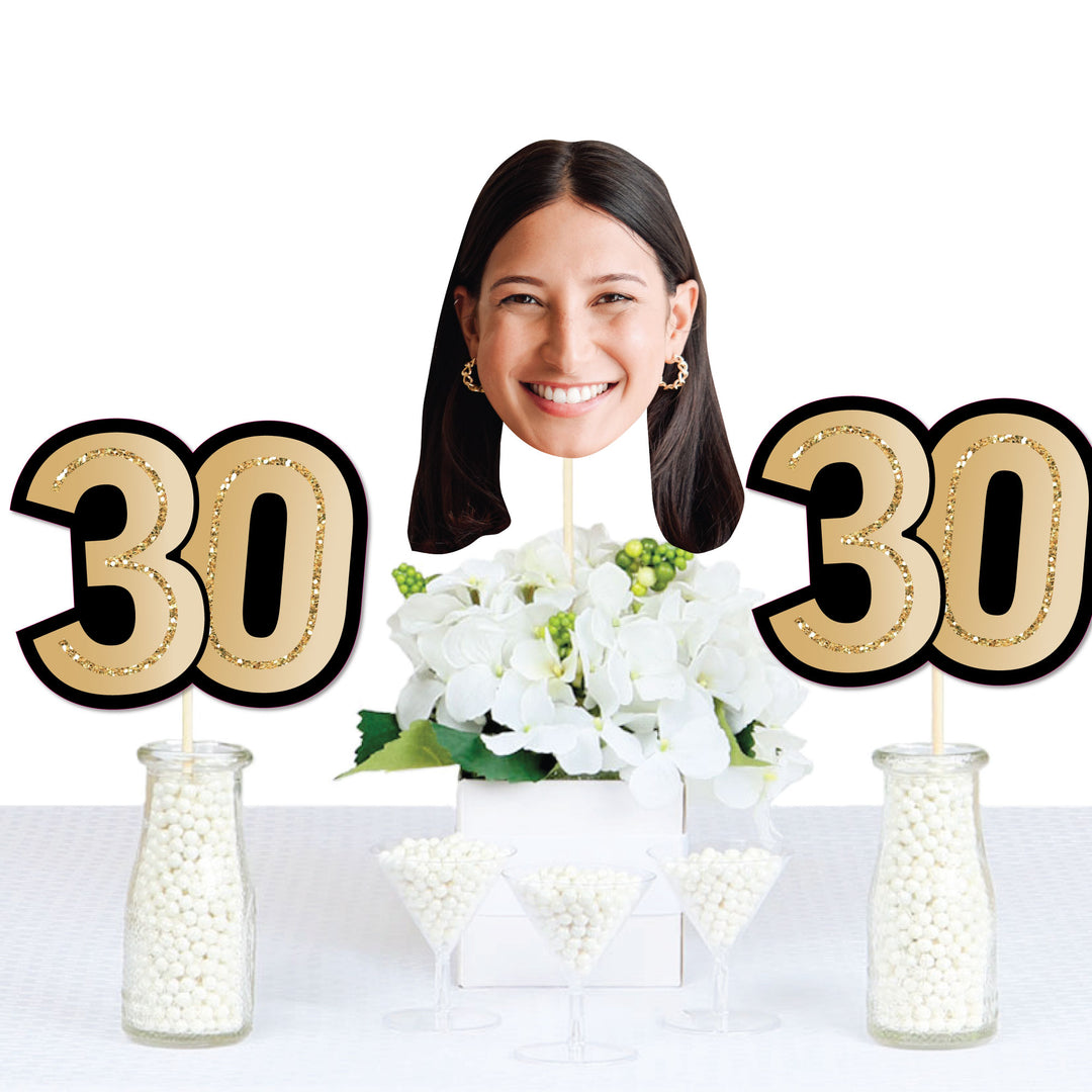 30th birthday party table decorated with custom face and number cutouts
