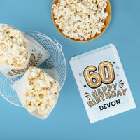 Popcorn in bags and a bowl with custom text '60 Happy Birthday Devon'