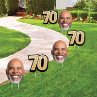 Yard Signs with Custom faces and '70' signs on a lawn.