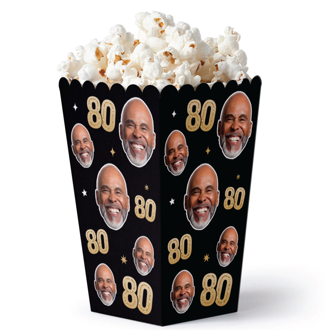 Popcorn bucket with faces and '80' text on a black background