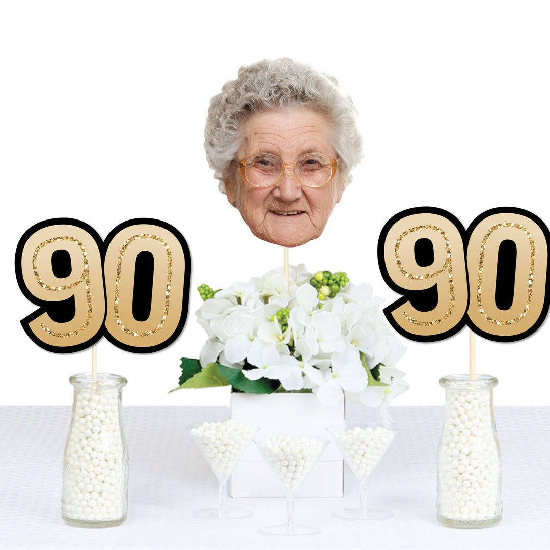 90th birthday party table featuring custom face decorations