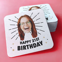 Personalized coaster with a photo of a person and 'Happy 21st Birthday' text on a pink background.