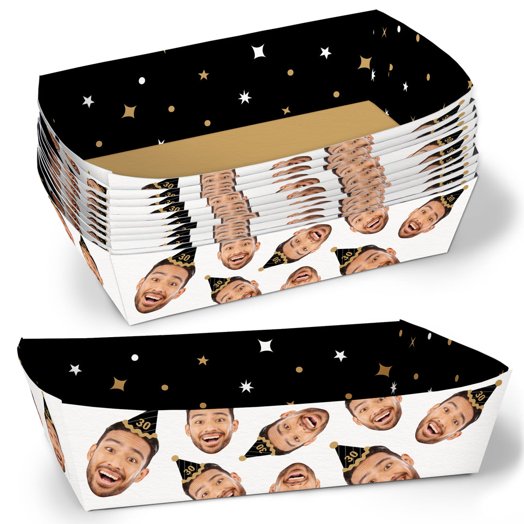 Two custom face black and gold paper food trays with a pattern of faces on a white background