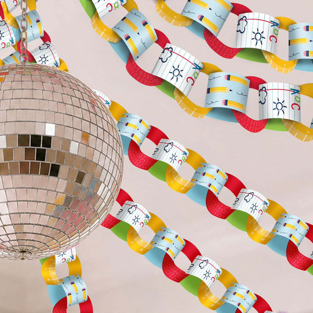 Colorful classroom paper chain with alphabet characters next to a disco ball on a beige background
