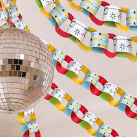 Colorful classroom paper chain with alphabet characters next to a disco ball on a beige background