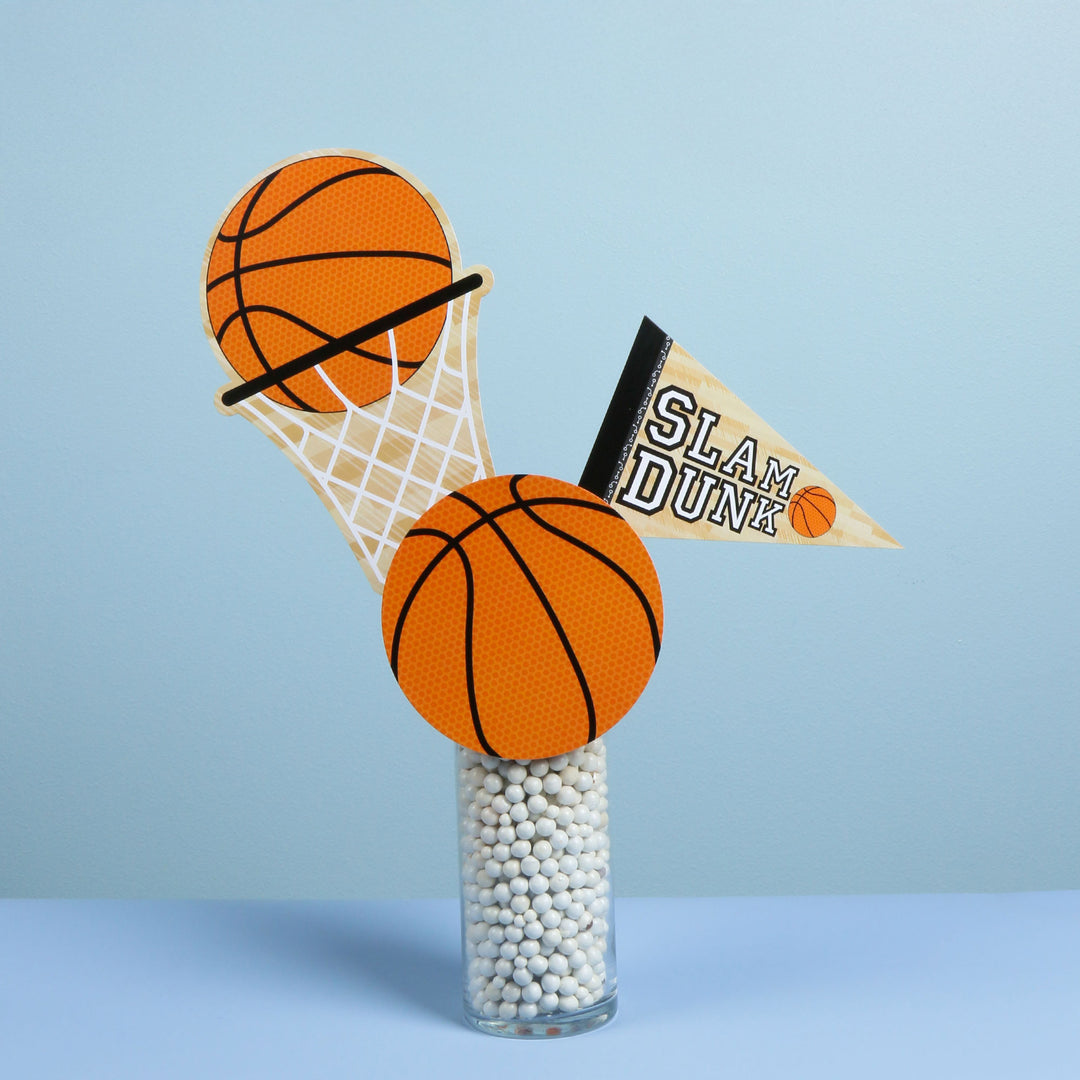 Decorative centerpiece with basketballs, hoop, and 'SLAM DUNK' pennant on a light blue background