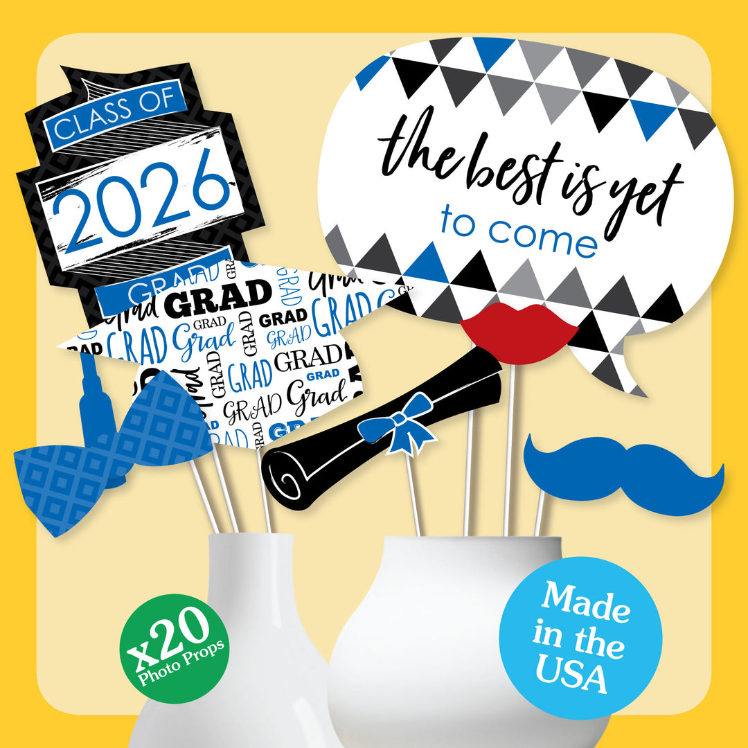 Graduation-themed photo props with 'Class of 2026' and 'GRAD' text on a yellow background.