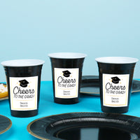 Black and white personalized graduation cups on drink table