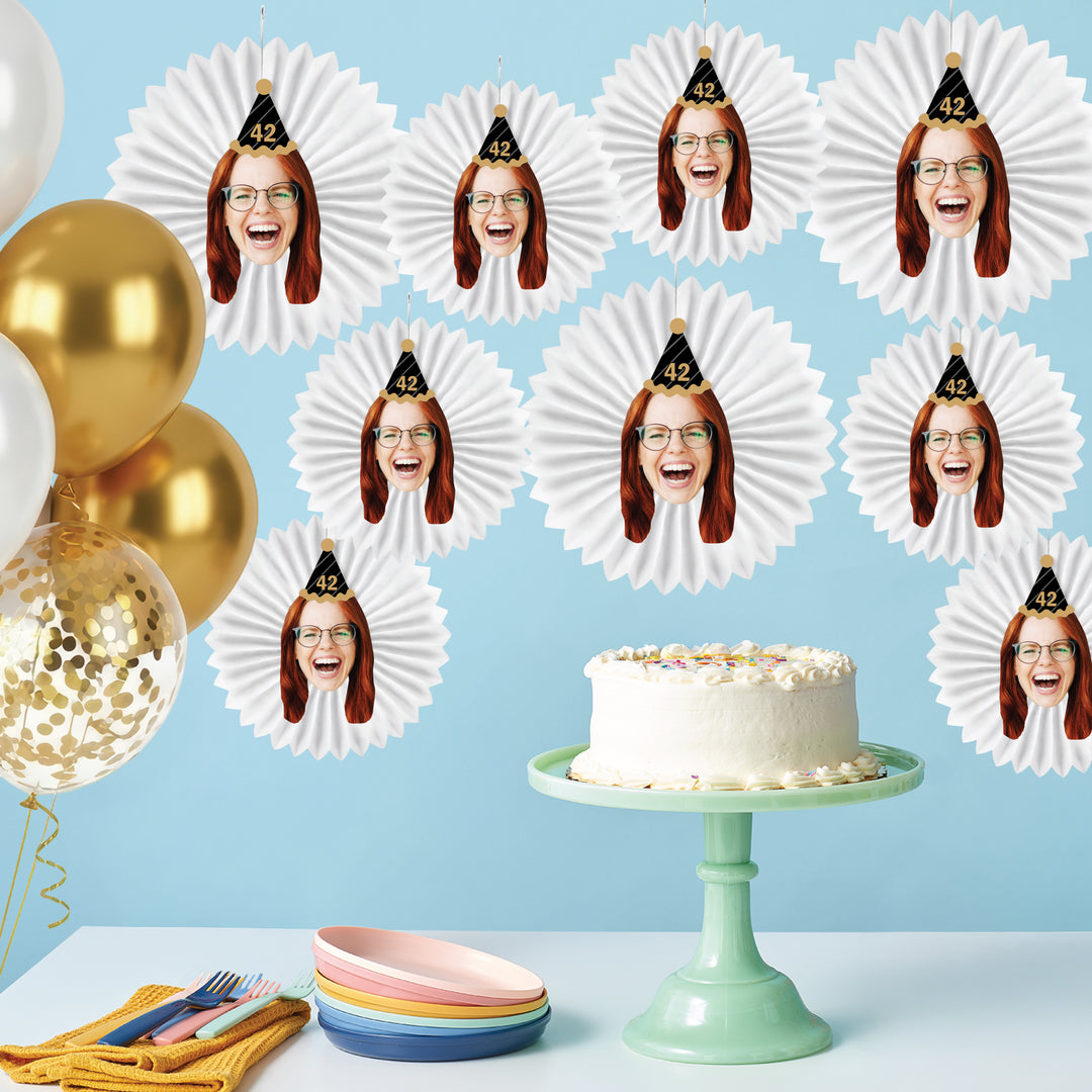 Custom birthday face paper fans styled as dessert table backdrop decor