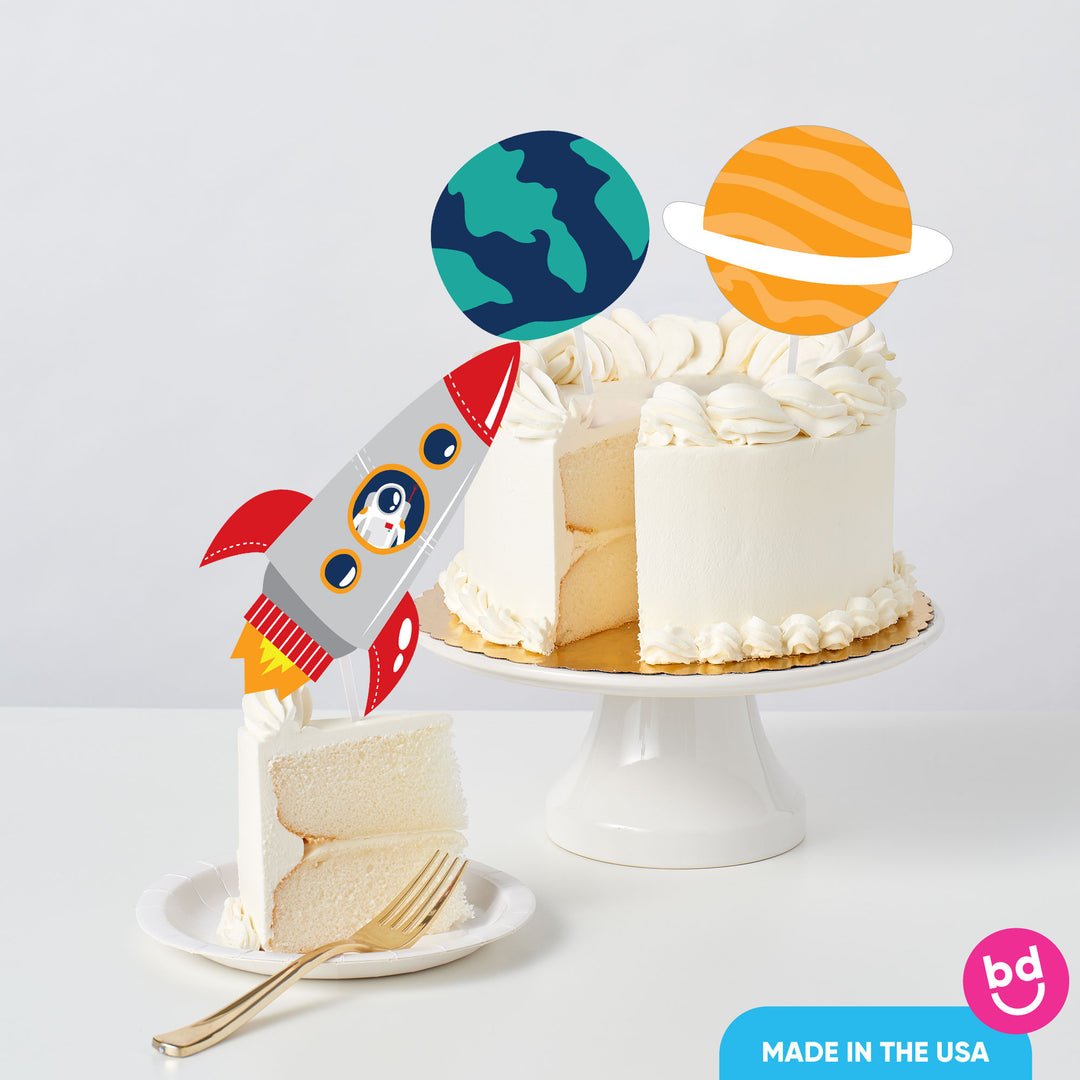 space themed birthday cake with topper decorations