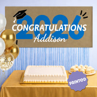 Blue 2026 graduation banner hanging as party backdrop
