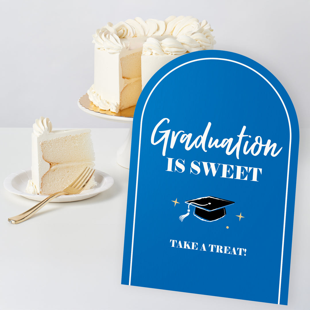 Close-up of blue graduation table sign design for grad party dessert table