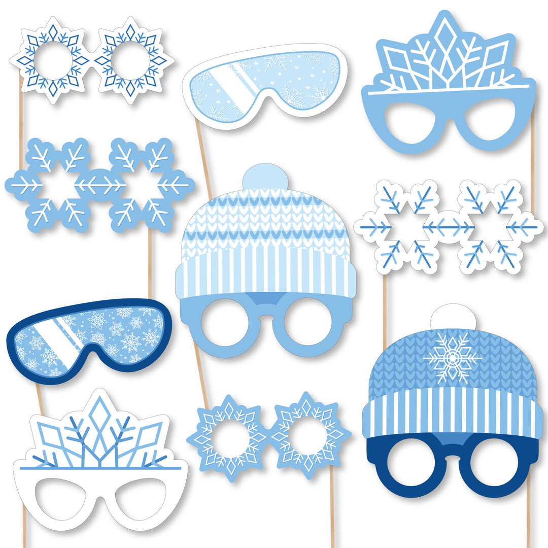 A collection of blue snowflake-themed photo booth props, including glasses and headpieces, printed on heavy cardstock paper.