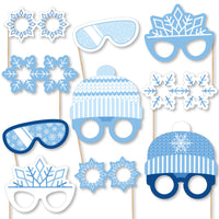 A collection of blue snowflake-themed photo booth props, including glasses and headpieces, printed on heavy cardstock paper.