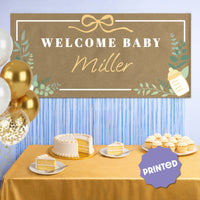Botanical baby shower banner styled behind gift table