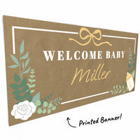 Greenery and floral artwork close-up on welcome baby banner