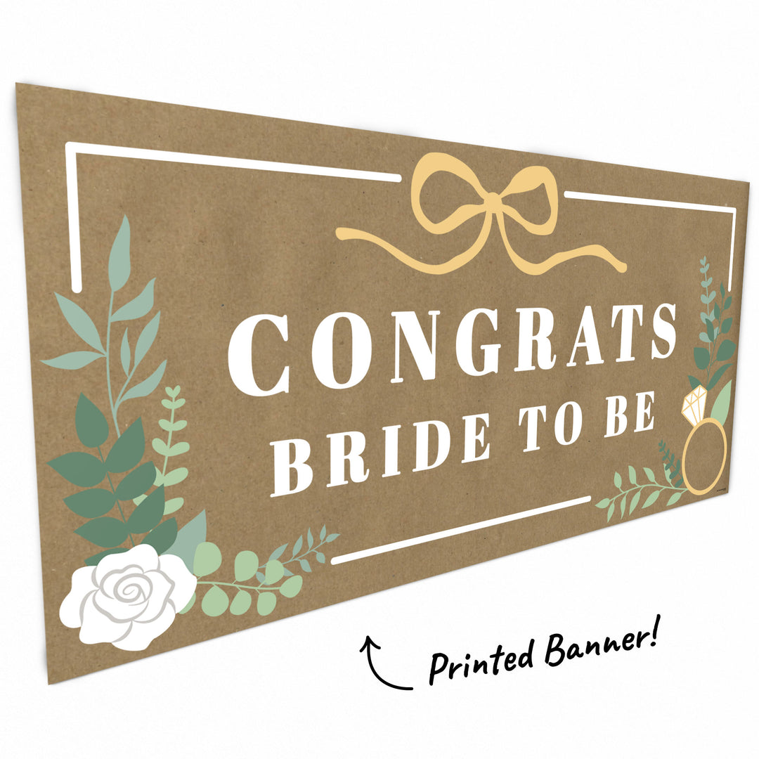 Close-up of greenery, bow, and ring detail on bridal banner