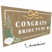 Close-up of greenery, bow, and ring detail on bridal banner