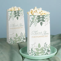 Two popcorn bags with leaf patterns and 'Thank You FOR POPPING BY!' text on a light blue background.