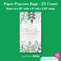 White paper popcorn bag with green leaf design and text on a green background