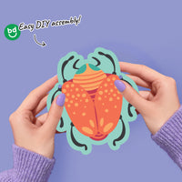 Children’s bug party decor garland with colorful critter cutouts on string.