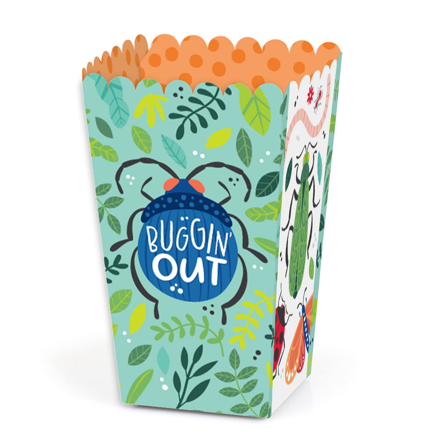 A colorful popcorn treat box with a bug theme, featuring various insects and the text 'BUGGIN' OUT' on a blue background.
