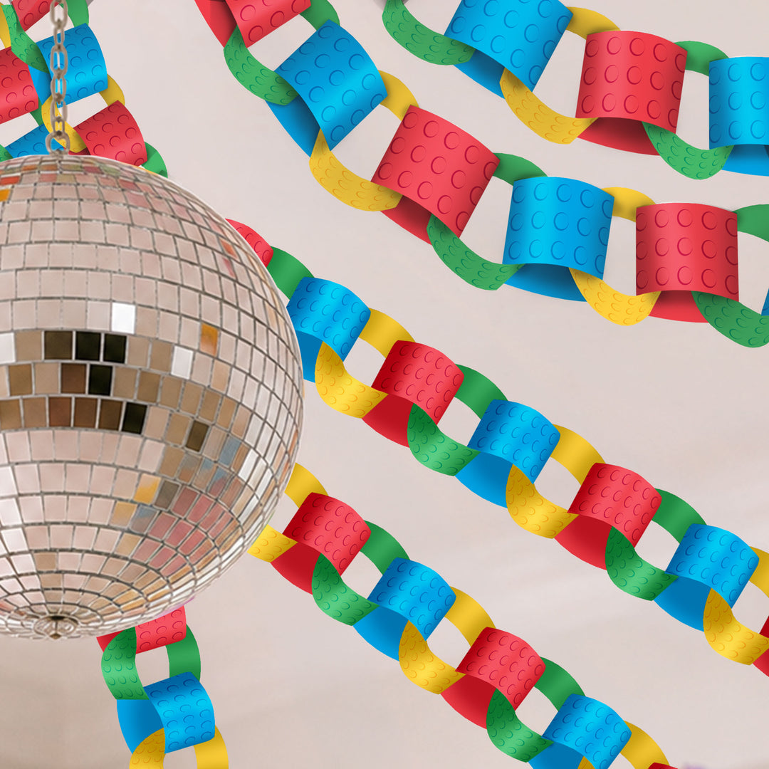 Colorful lego party themed paper chain with a disco ball on a neutral background