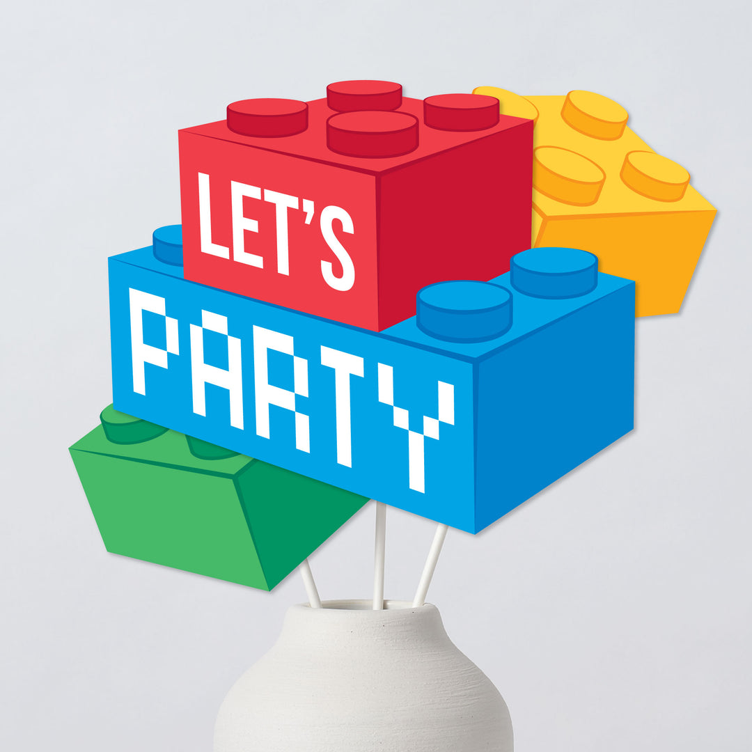 Colorful block design party centerpieces with 'LET'S PARTY' text in a white vase on a light gray background