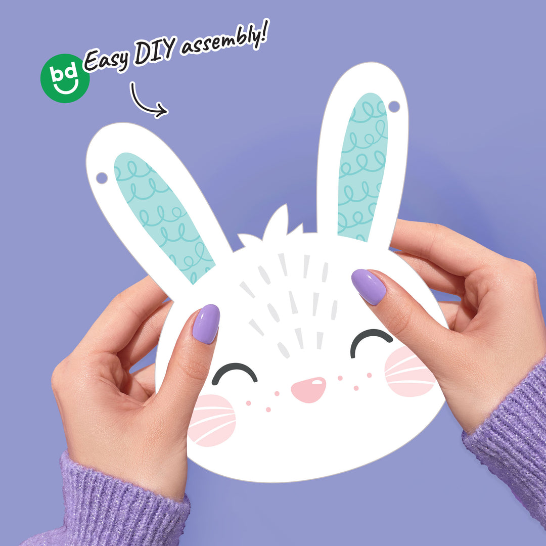 Hands holding a bunny face banner pennant with 'bd' logo and text on a purple background