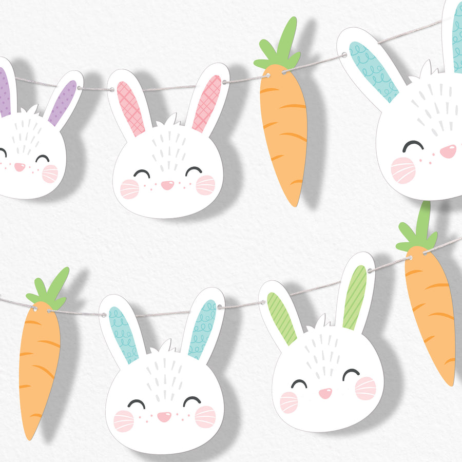 Decorative Easter banner with cartoonish bunnies and carrots on a white background