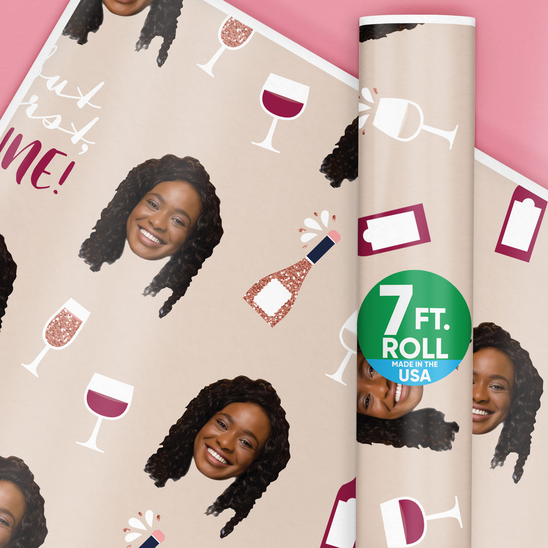 Wine-themed wrapping paper with a woman's face and wine glasses on a pink background.
