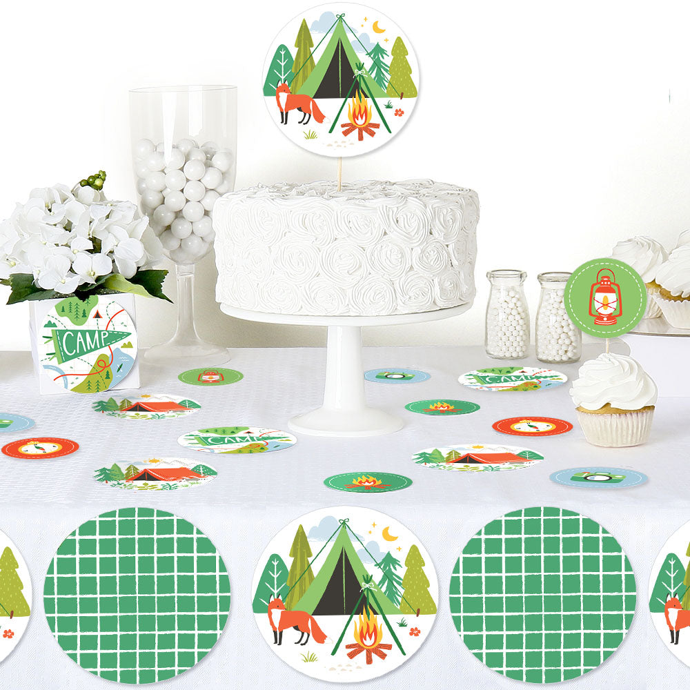 Camping birthday party table styled with scattered confetti decor