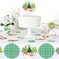 Camping birthday party table styled with scattered confetti decor