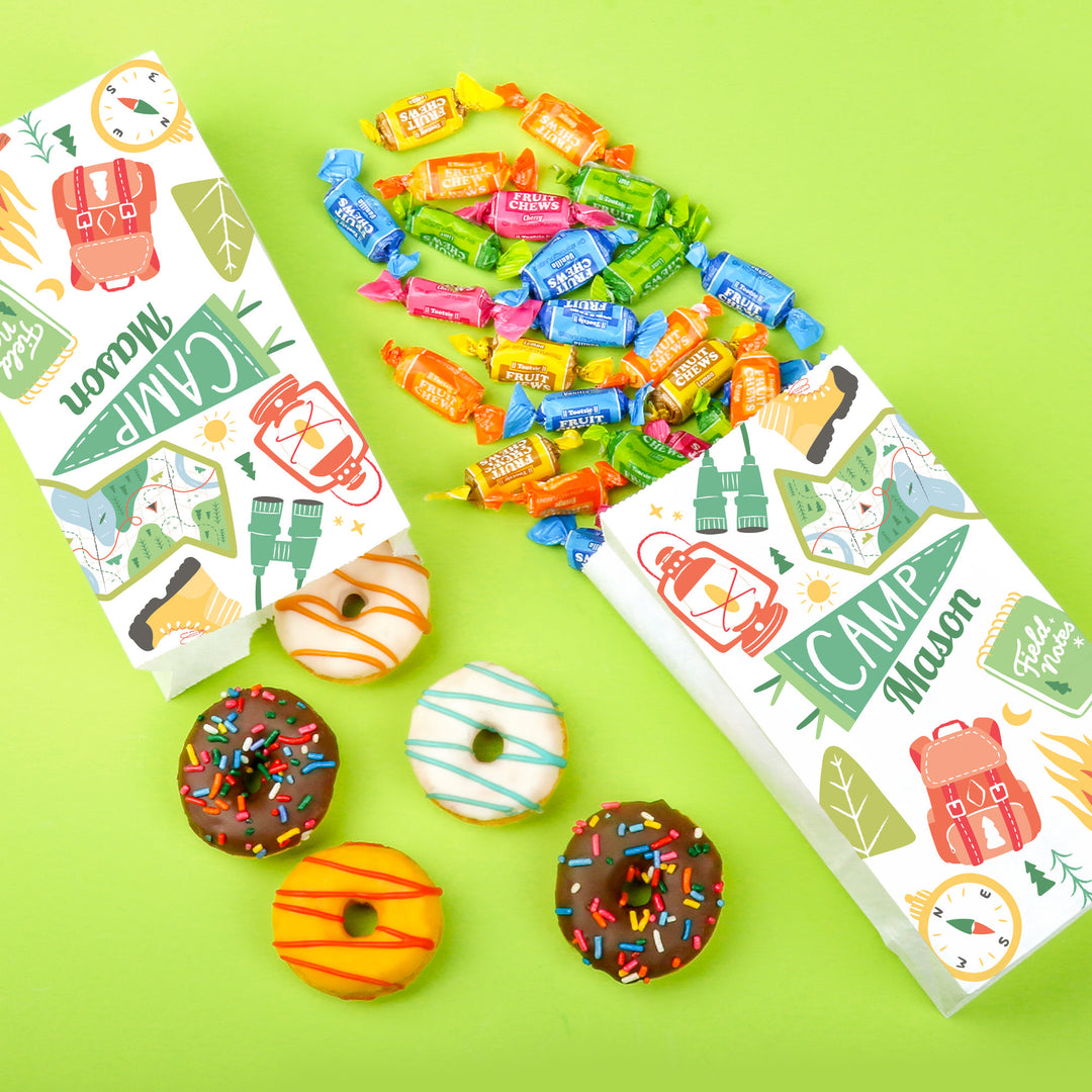 Camping birthday party snack table with custom bags