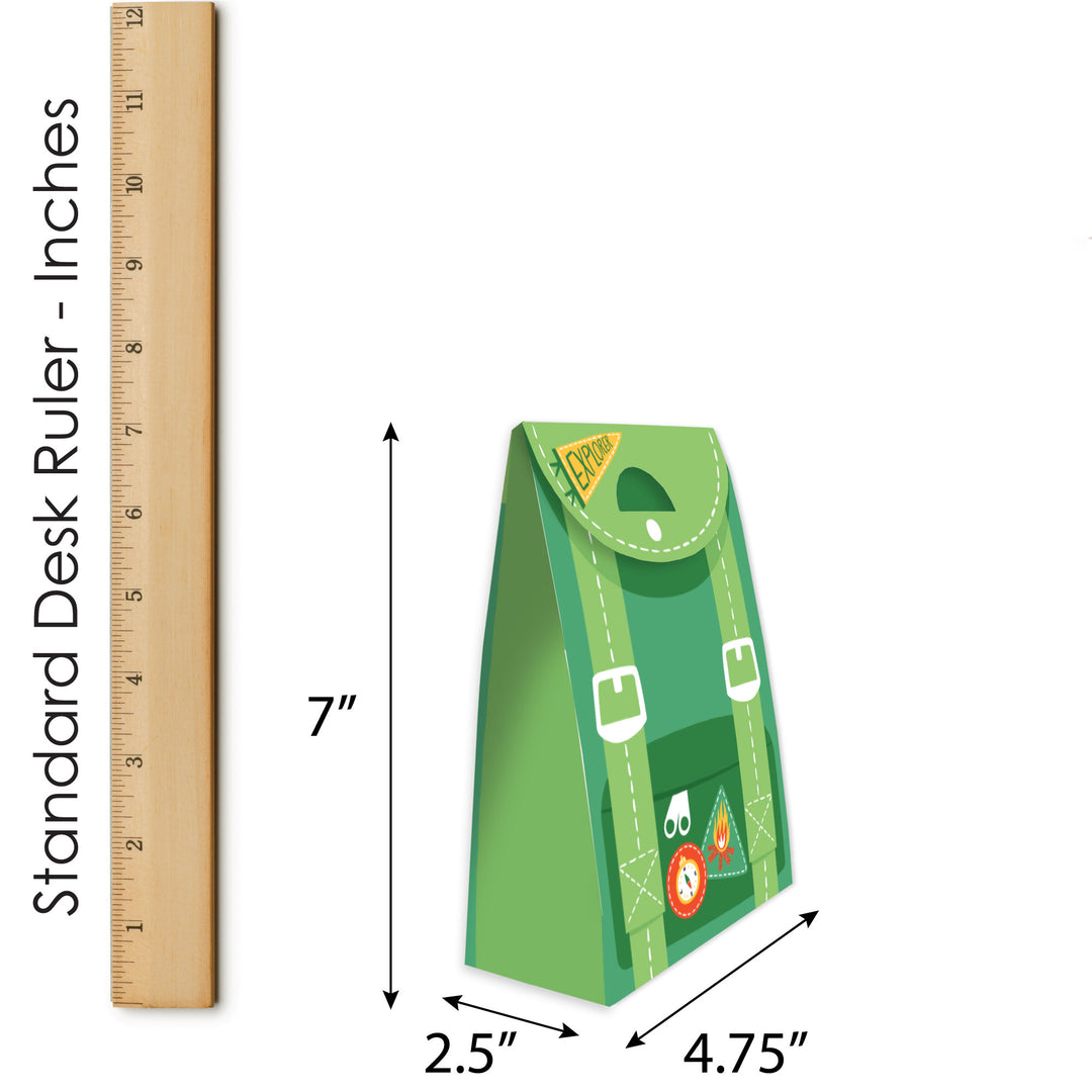 Green paper bag with buckle details next to a ruler for size measurement on a white background