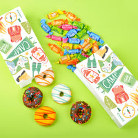 Camping birthday party snack table with popcorn bags