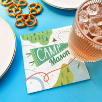 Camping birthday party table setup with custom napkins