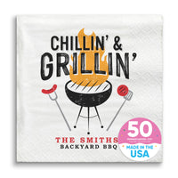 A white paper napkin with 'CHILLIN' & GRILLIN" text and an illustration of a grill and utensils. Custom text reads 'THE SMITHS' BACKYARD BBQ'.