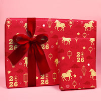 lunar new year 2026 Red gift box with gold patterns and a large red bow on a pink background