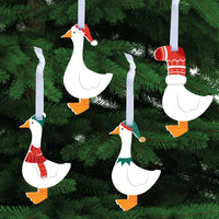 Decorative goose ornaments with festive hats and scarves on a Christmas tree.