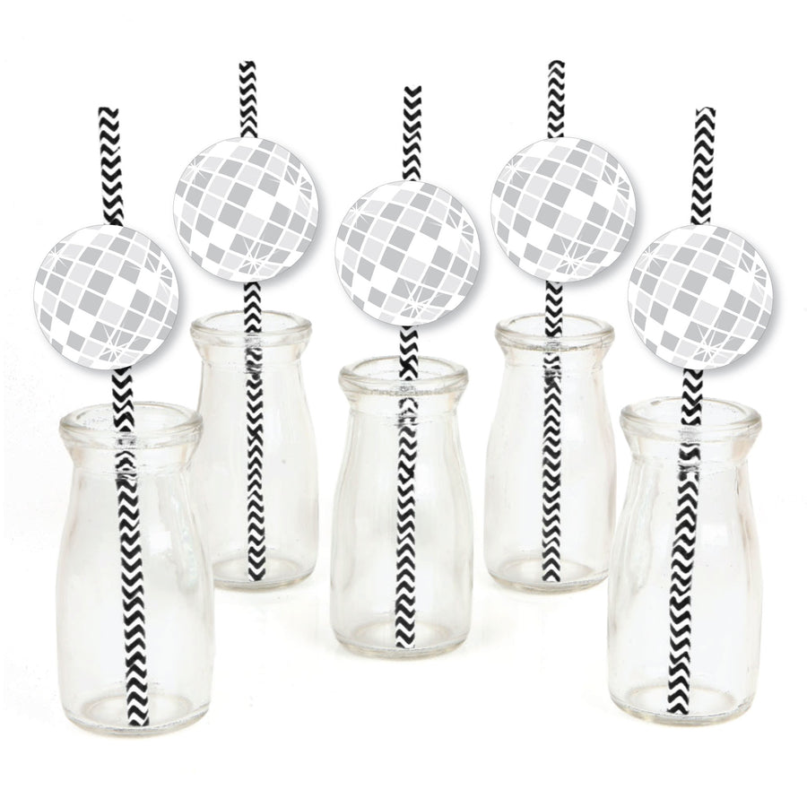 A set of paper straw decorations with striped patterns and disco ball shapes on them, displayed alongside clear glass bottles and jars.