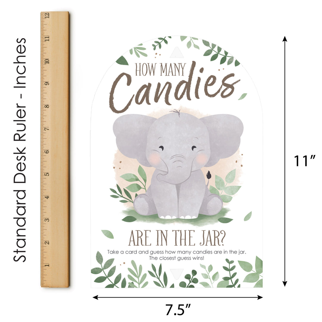 Baby Shower game with an elephant and text about guessing candies in a jar, next to a ruler for size reference.