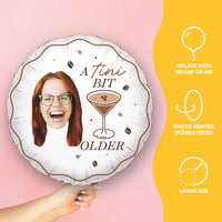 Balloon with a printed design of a woman's face, a cocktail, and text on a pink background.