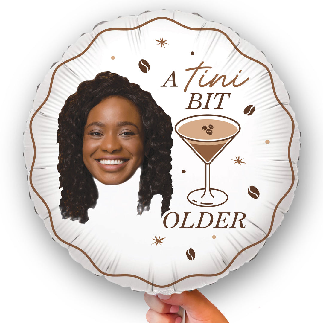 Custom Round balloon with a design of a woman's face, a martini glass, and text on a white background. A Tini Bit Older