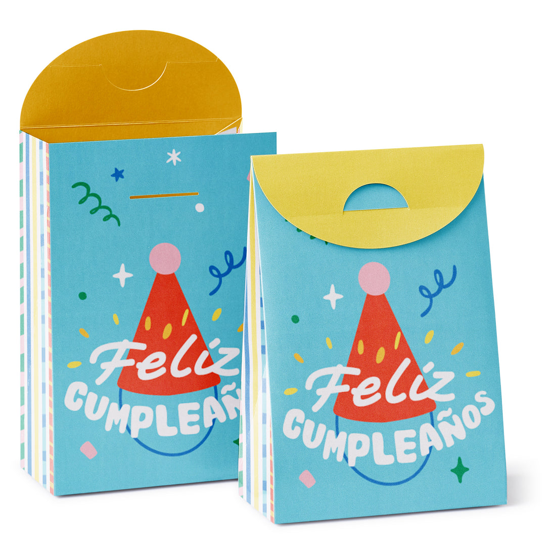 A stack of two Feliz Cumpleaños themed goodie bags with a party hat design, in blue and yellow colors, with creases and tabs visible for assembly.