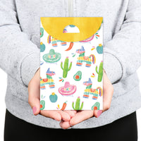 Person holding a colorful gift bag with Mexican-themed design