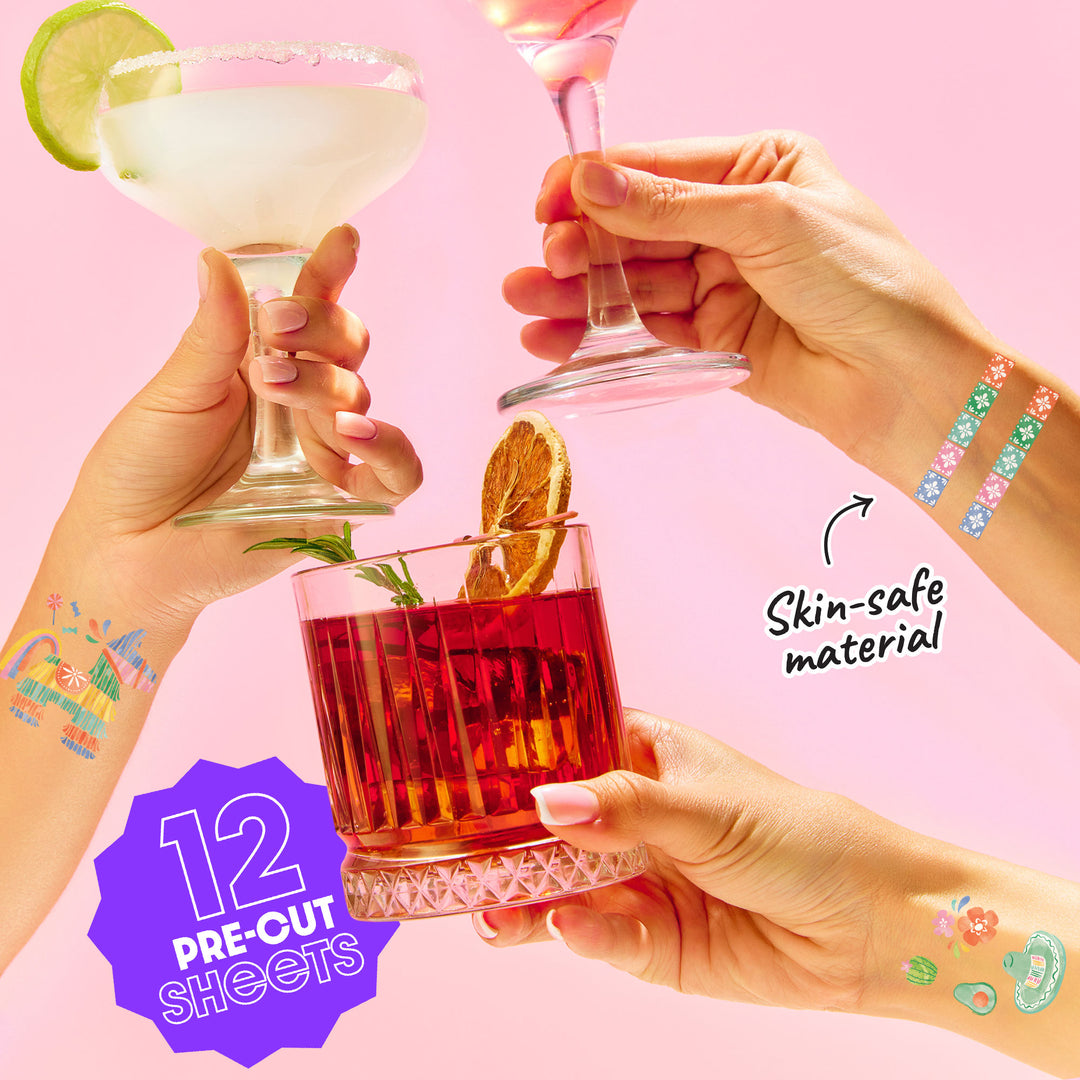 Three hands holding cocktails with tattoos on a pink background, featuring 'Skin-safe material' text.